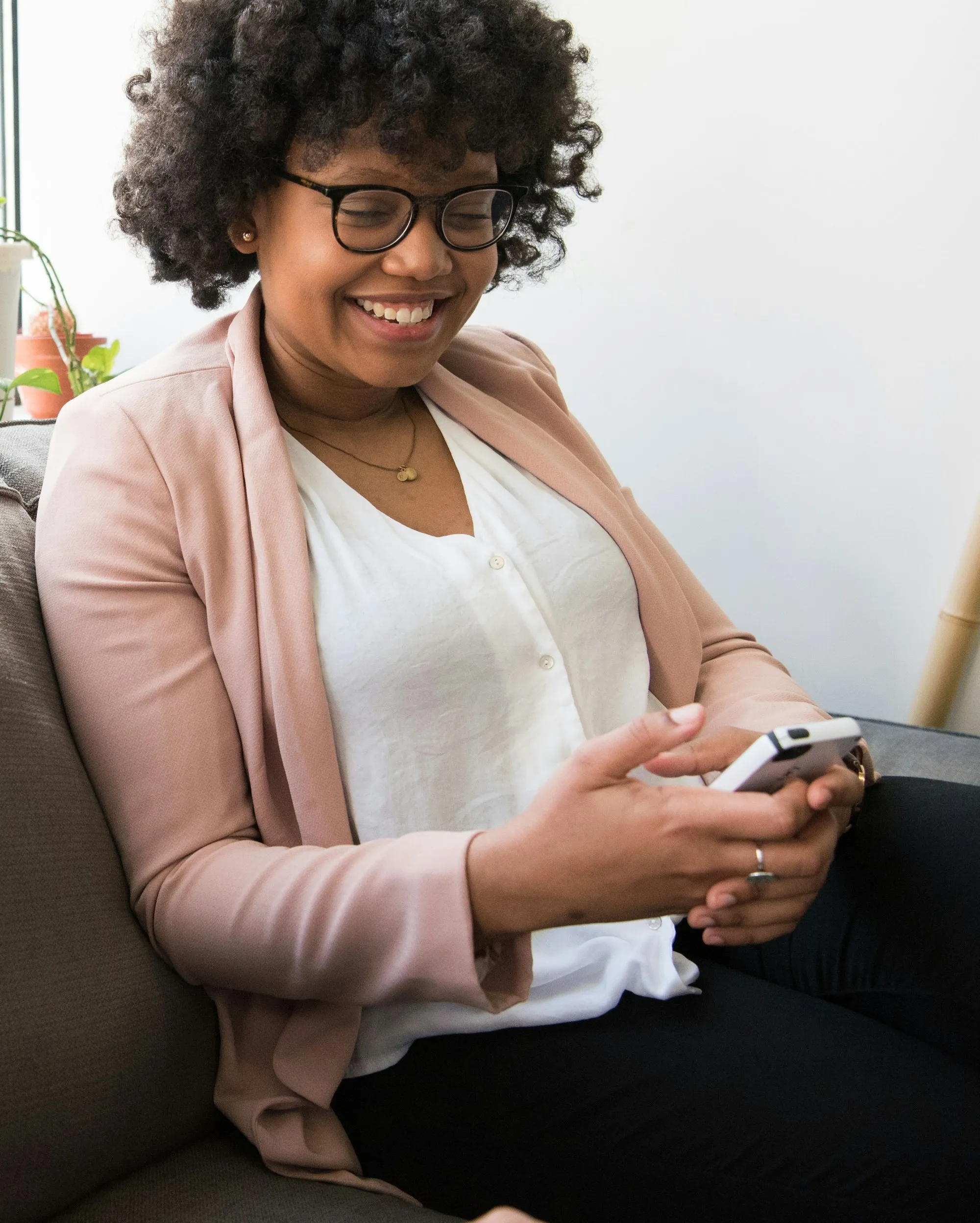 A woman smiling at her phone